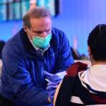 Flying home after the holidays? Getting vaccinated or boosted is the first step toward safe travel, expert says