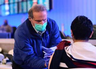Flying home after the holidays? Getting vaccinated or boosted is the first step toward safe travel, expert says